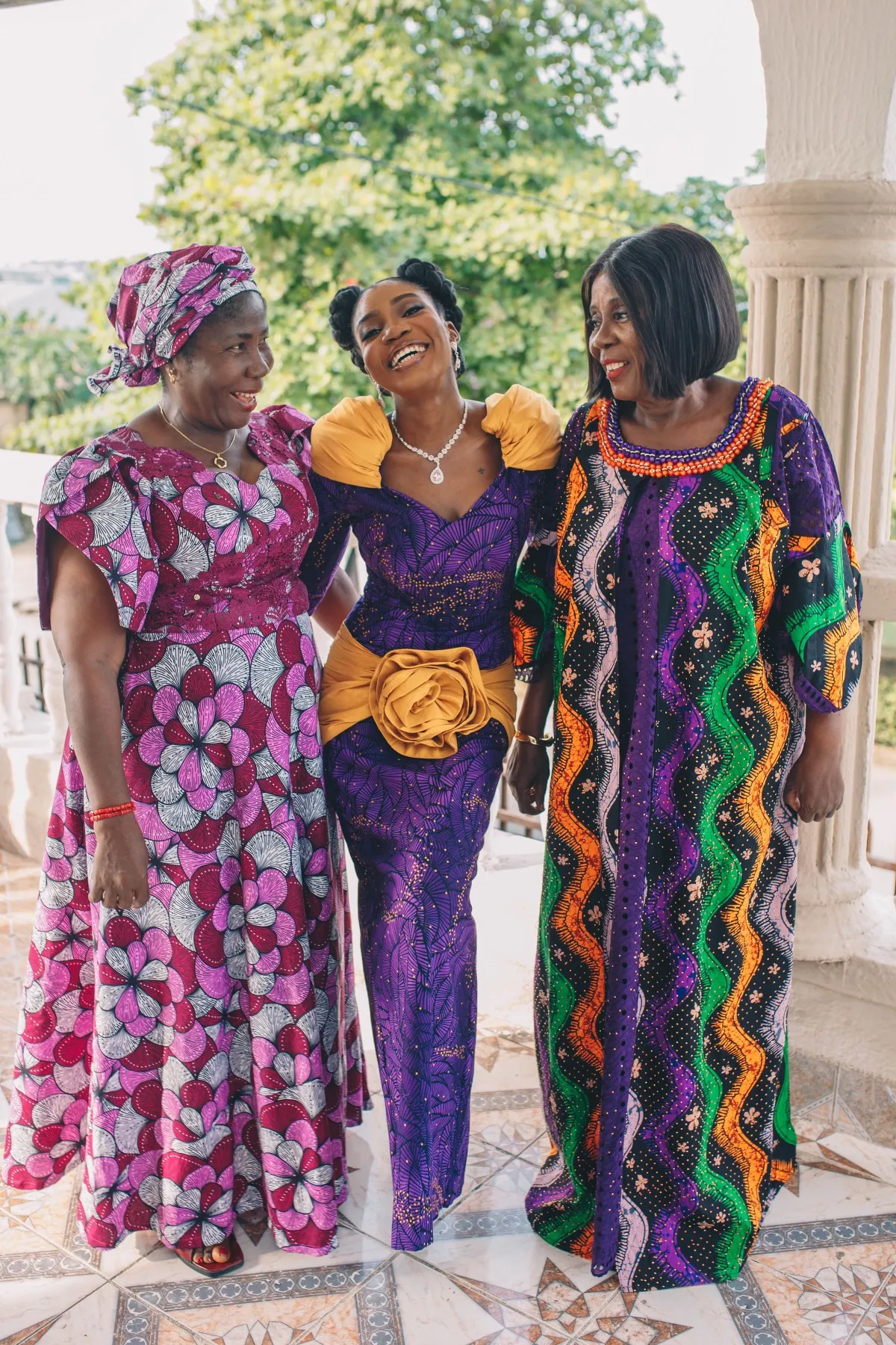 adeilé between two women in bright patterned wrappers