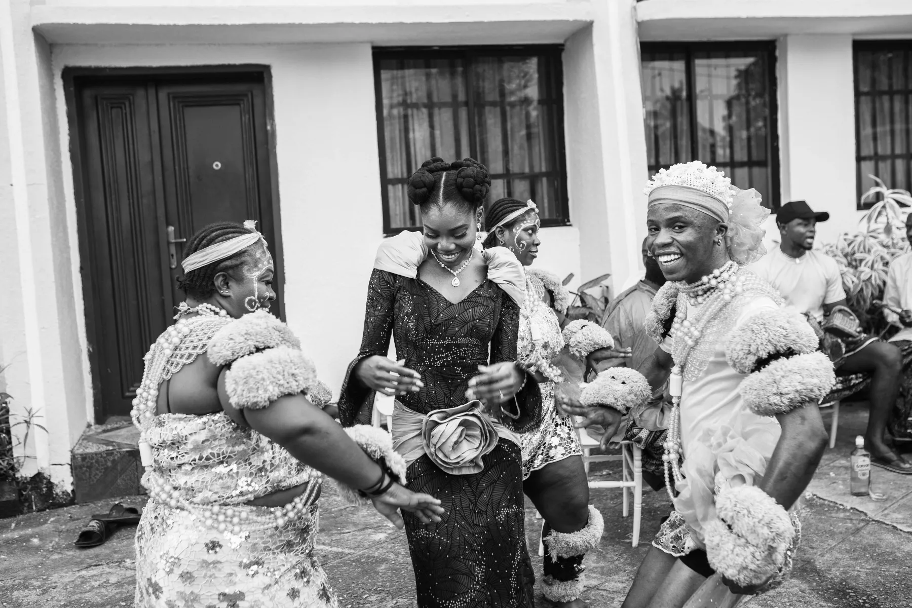 women dancing outside the house, black and white