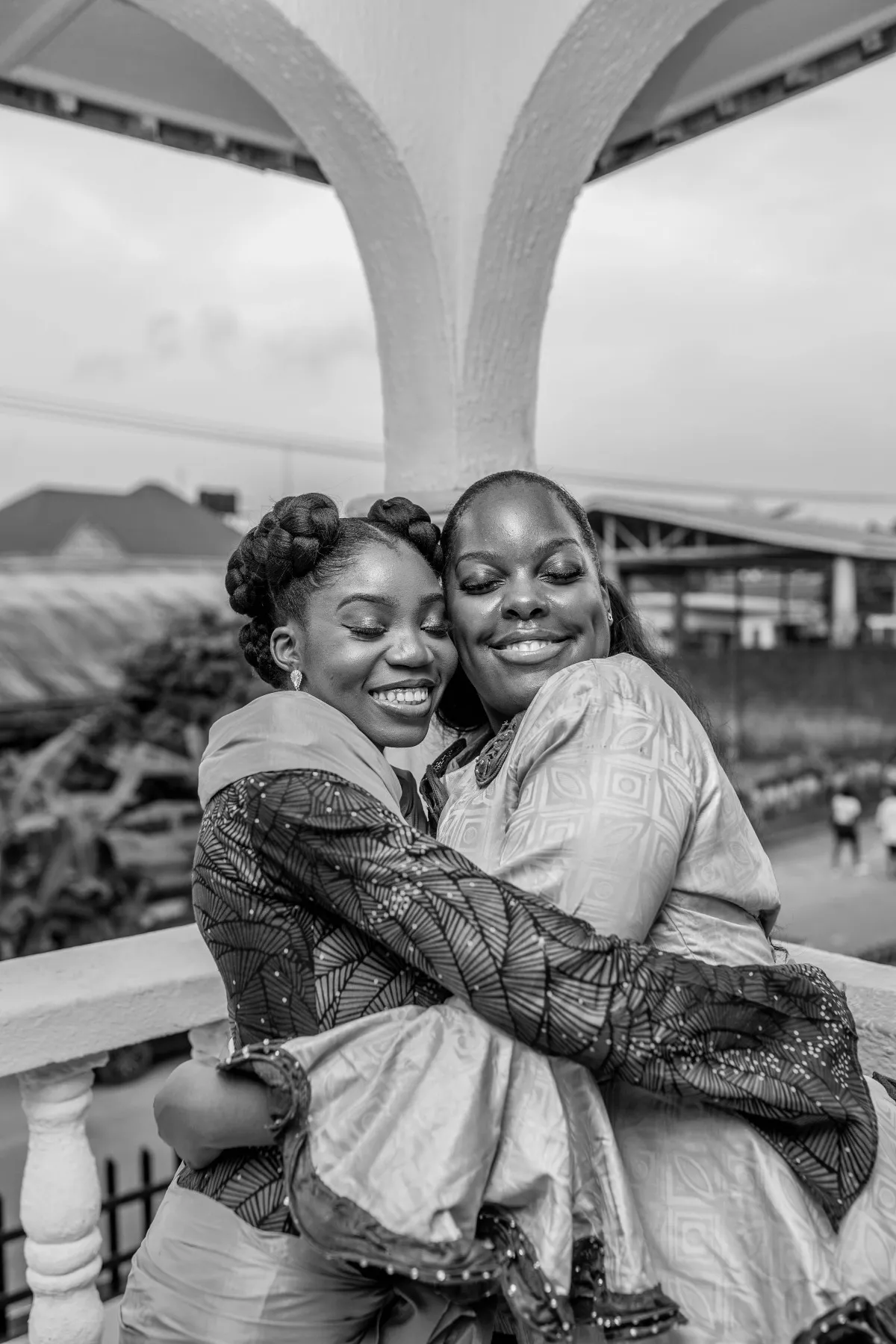 two women hugging on the balcony, black and white