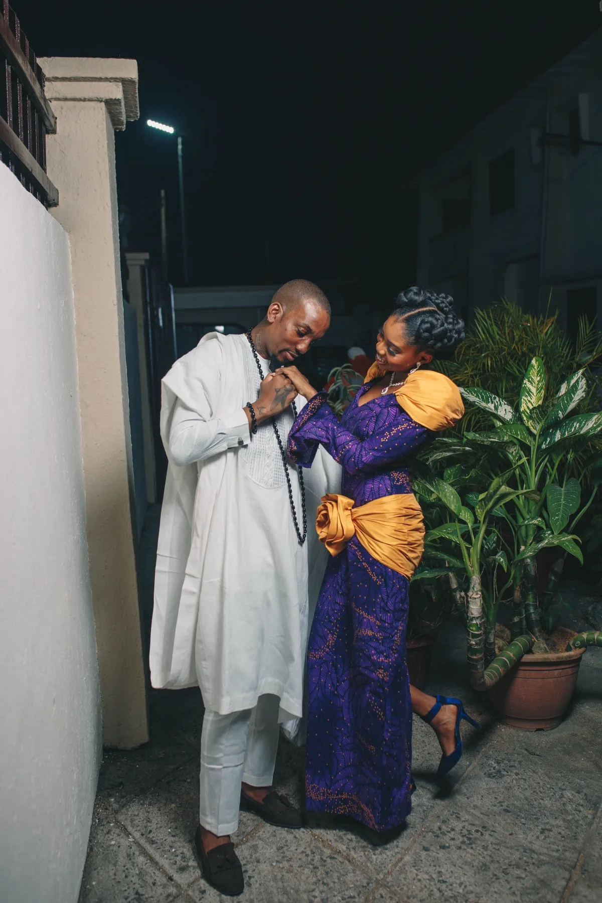 ekanem leaning in to adeilé at night