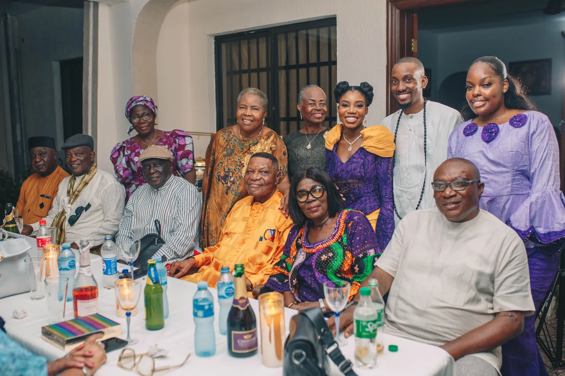 the families gathered at the table for a group photo